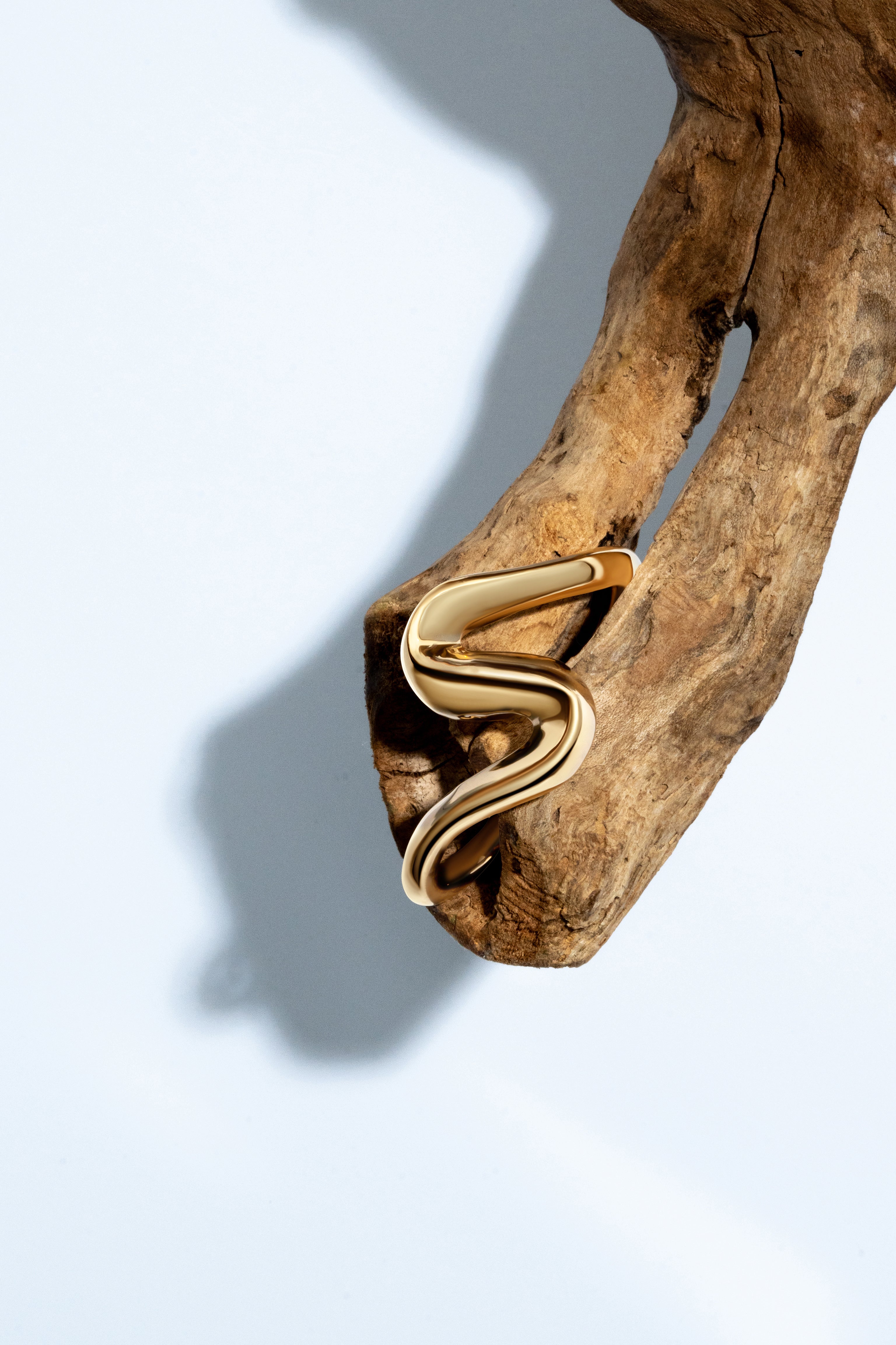 Gold sculptural cuff bracelet with S-shaped curves and 6mm thickness