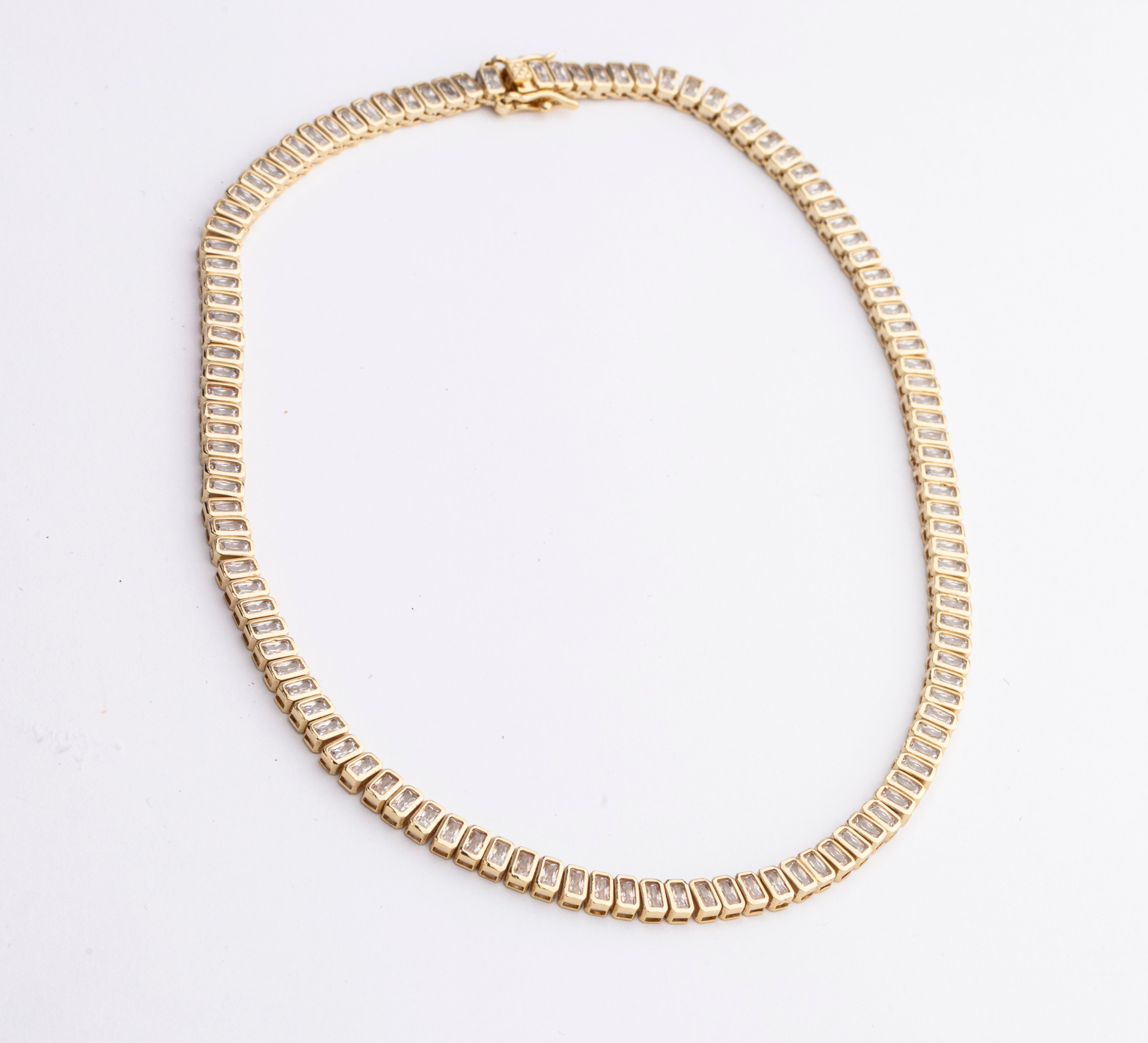 Cubic zirconia necklace available in gold plated and rhodium plated finishes with high shine