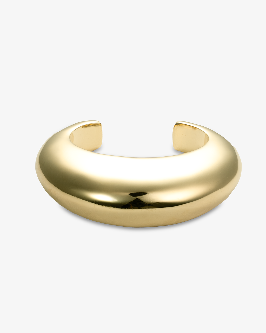 Gold chunky sculptural open cuff bracelet, alone product shot on a plain background.
