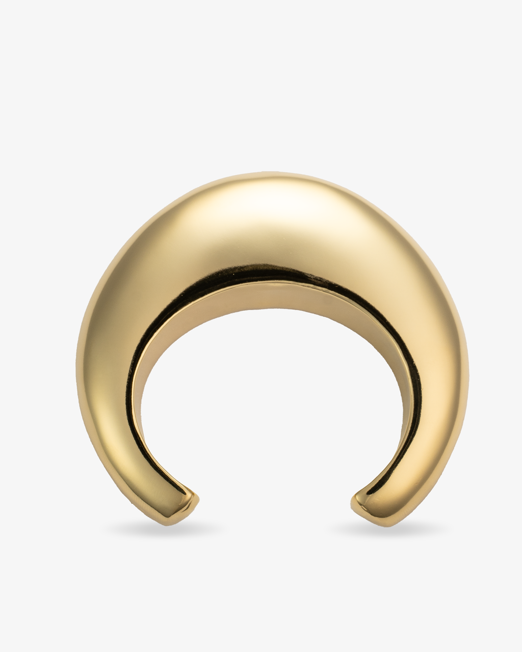 Gold chunky sculptural crescent-shaped cuff bracelet, alone product shot on a plain background.