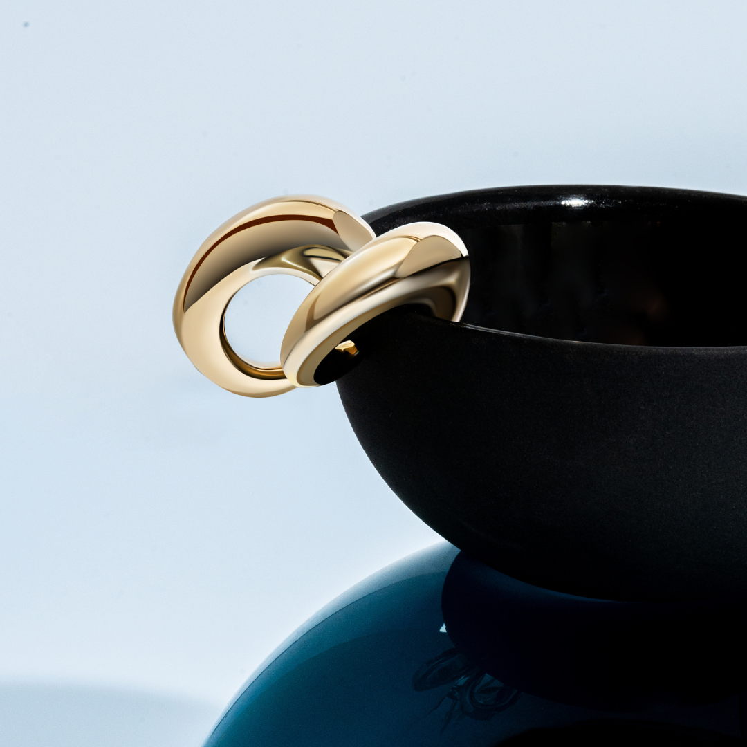 Oval open hoop earrings available in gold plated and rhodium plated finishes with sculptural thick design