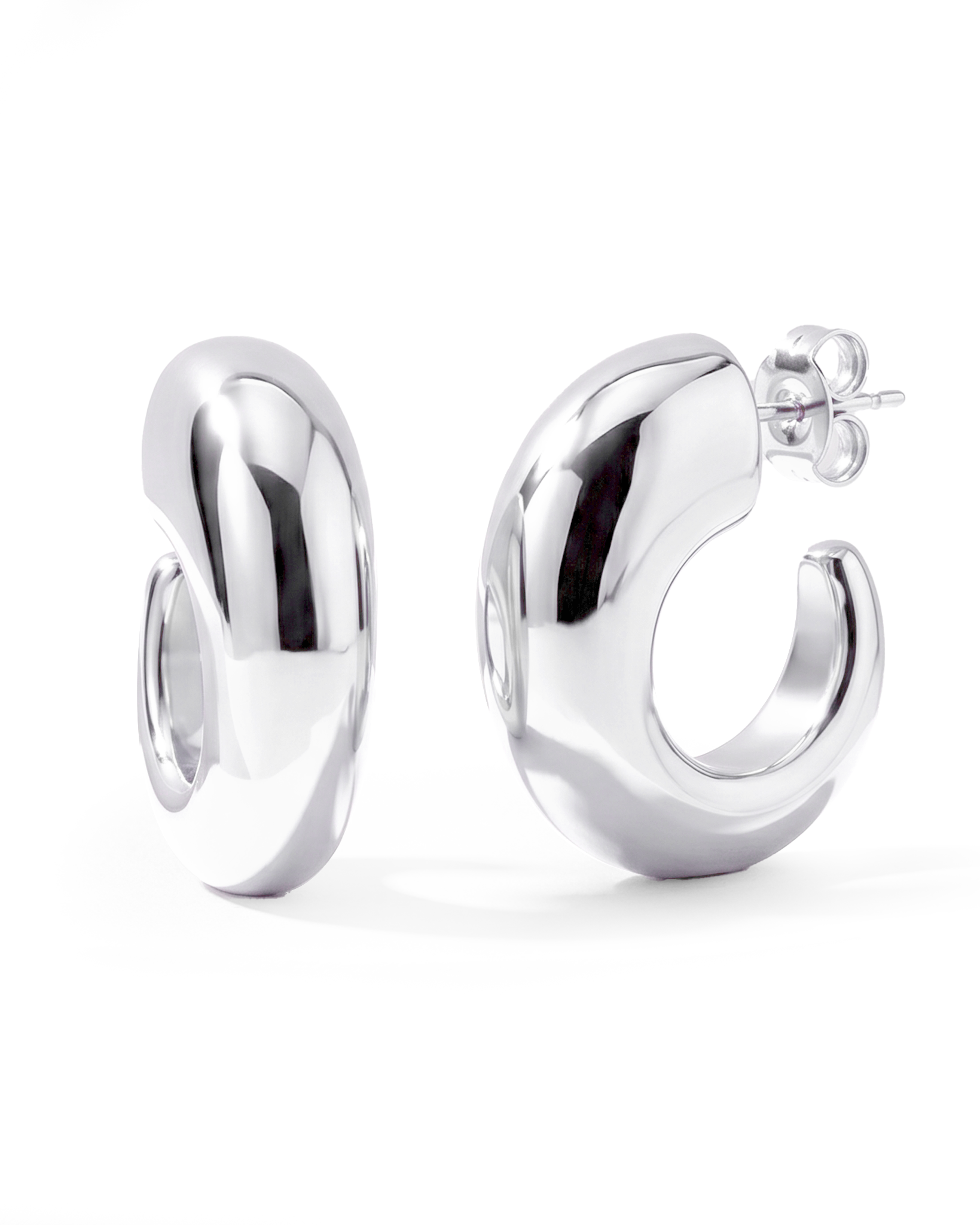 Oval open hoop earrings available in gold plated and rhodium plated finishes with sculptural thick design
