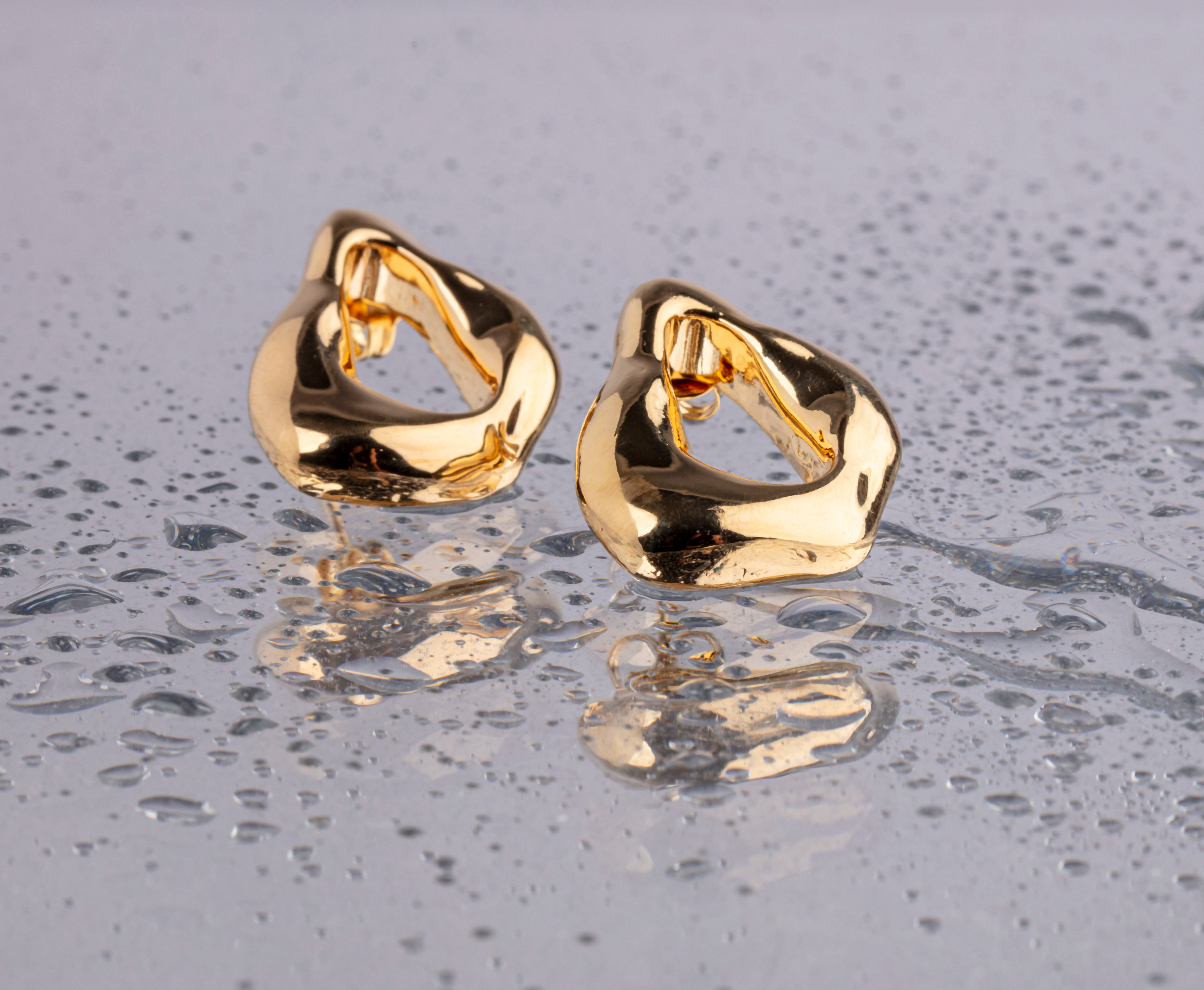 Minimal gold plated earrings with smooth polished surface and clean design