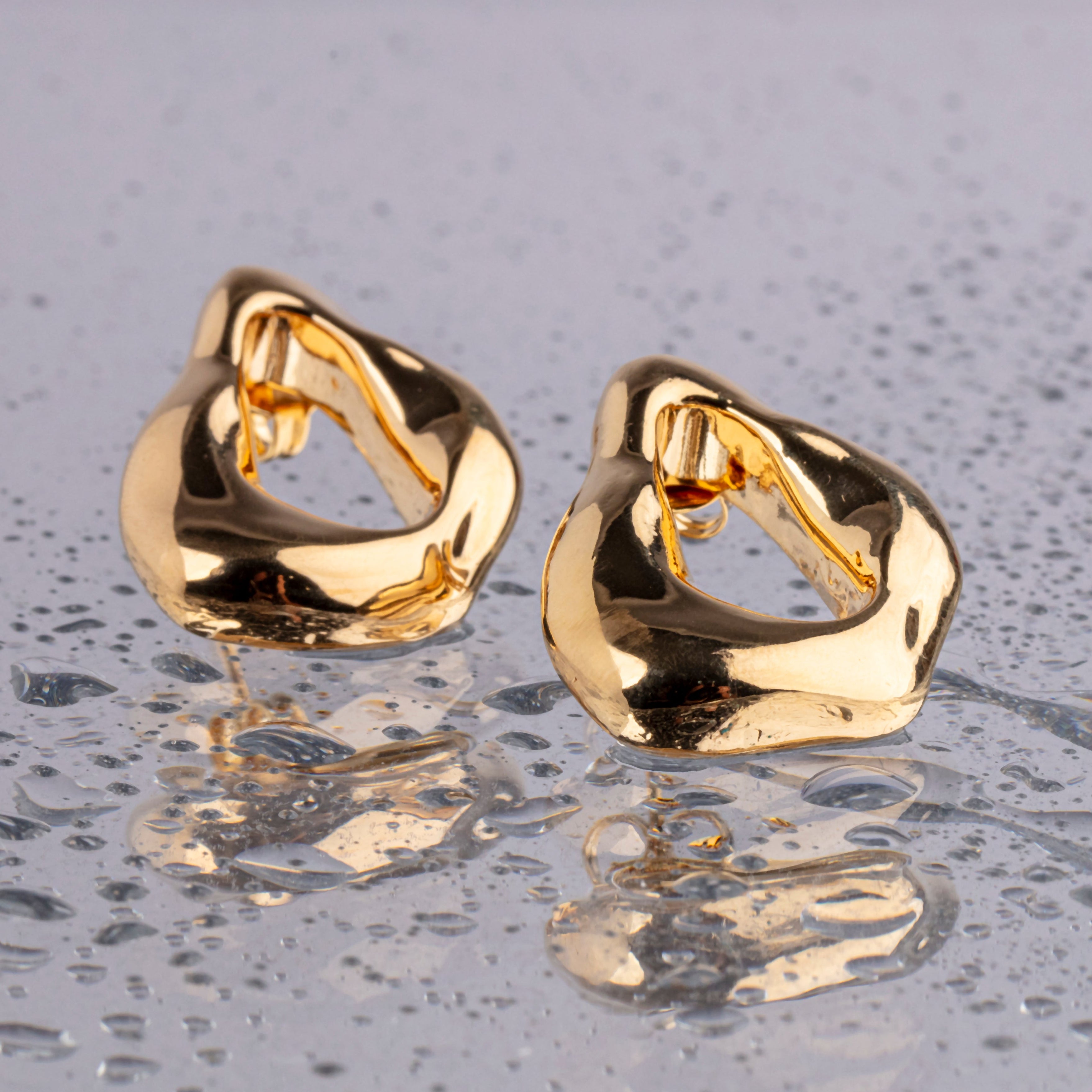 Minimal gold plated earrings with smooth polished surface and clean design