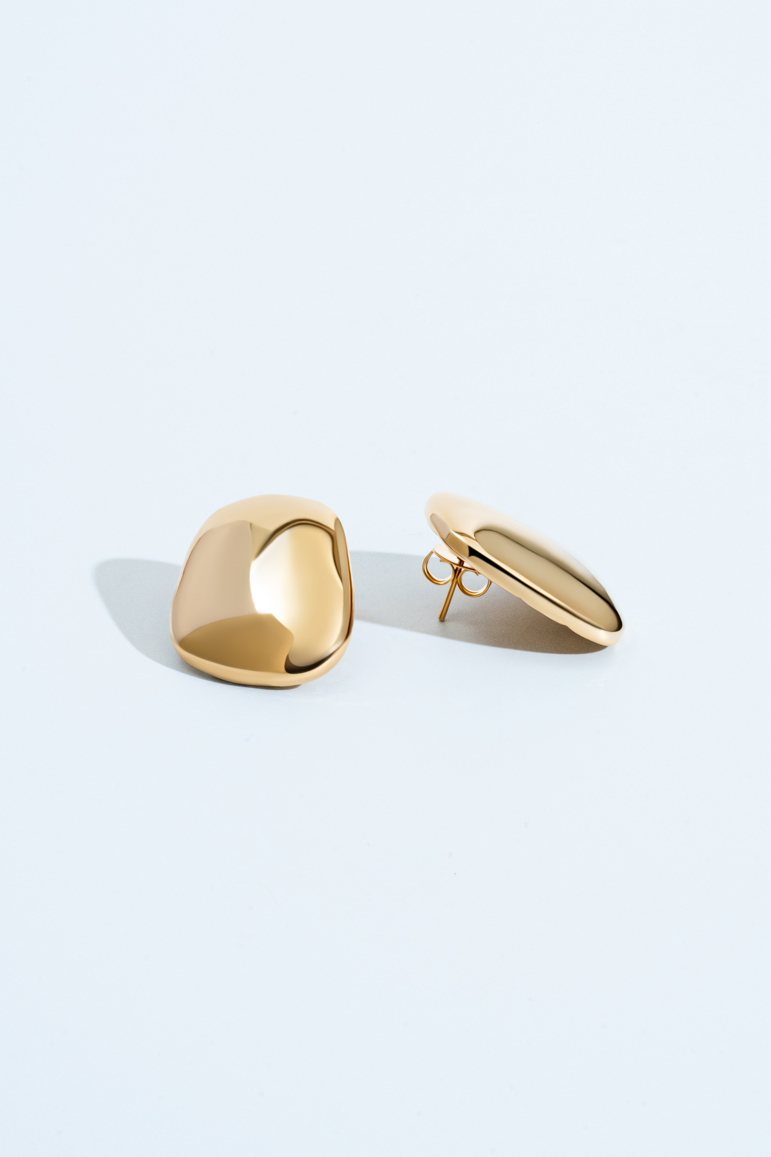 Gold geometric sculptural earrings with polished curved design