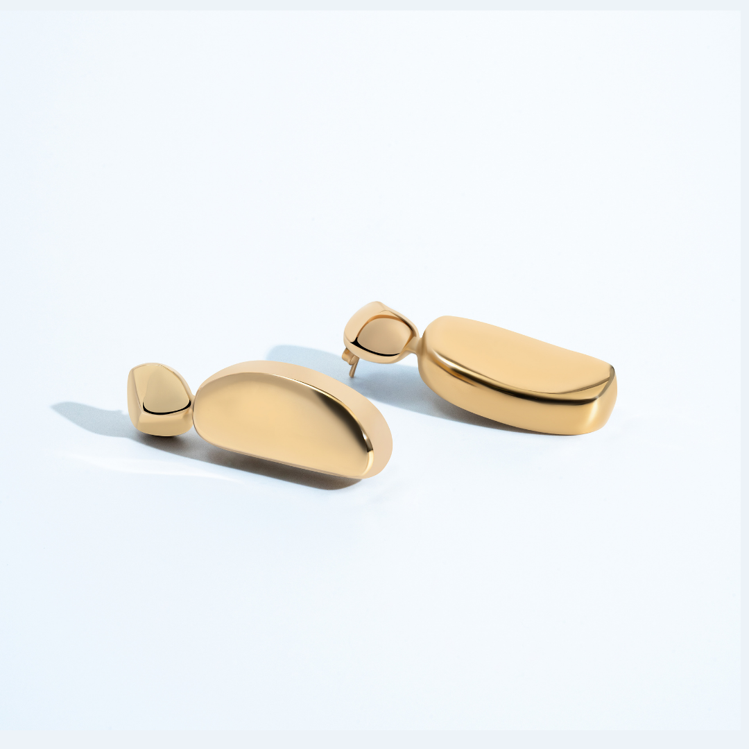Gold geometric statement earrings with sculptural curved design and polished finish