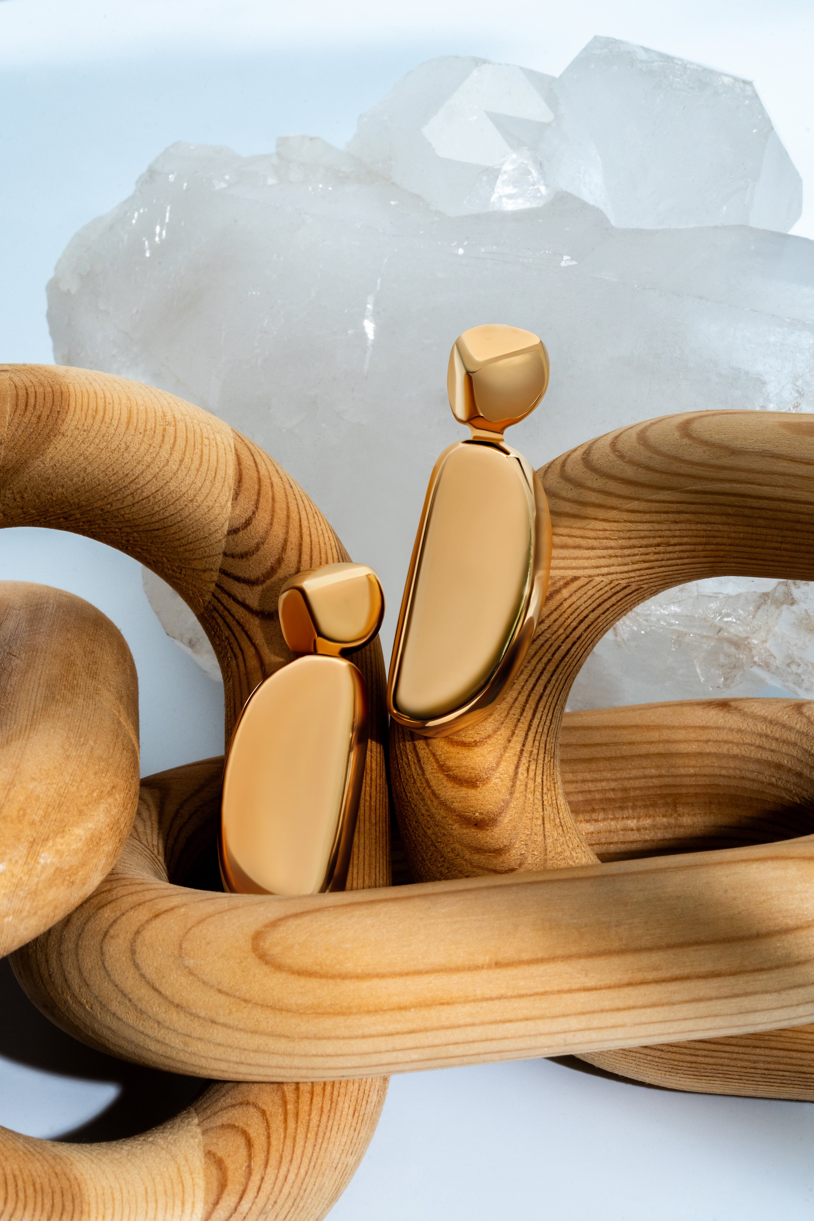 Gold geometric statement earrings with sculptural curved design and polished finish