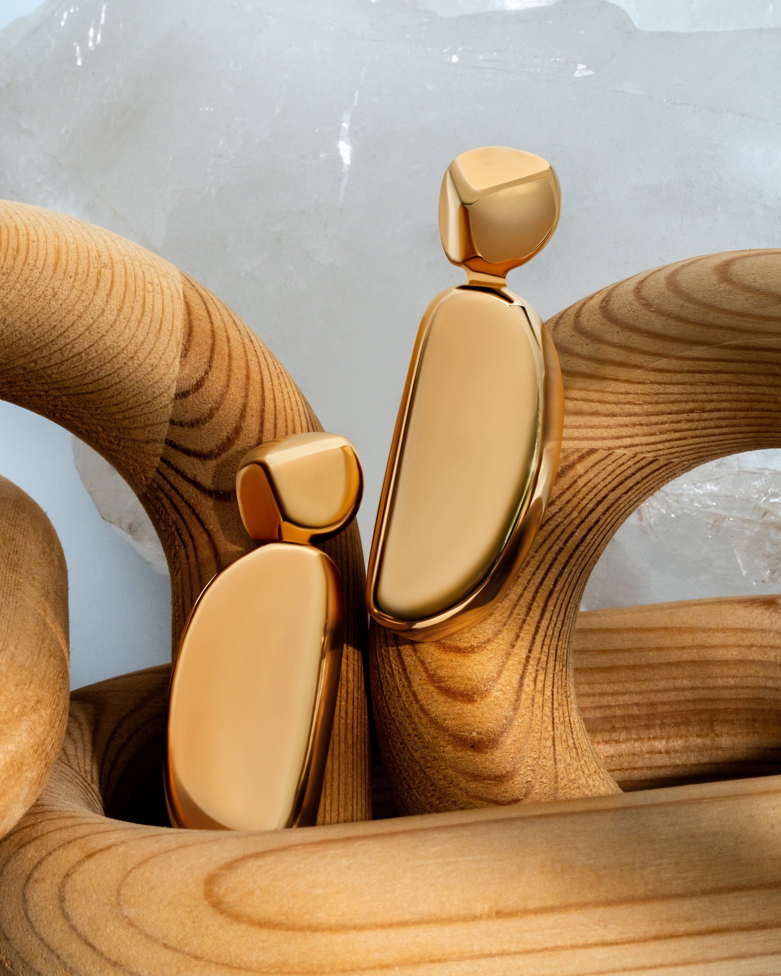 Gold geometric statement earrings with sculptural curved design and polished finish