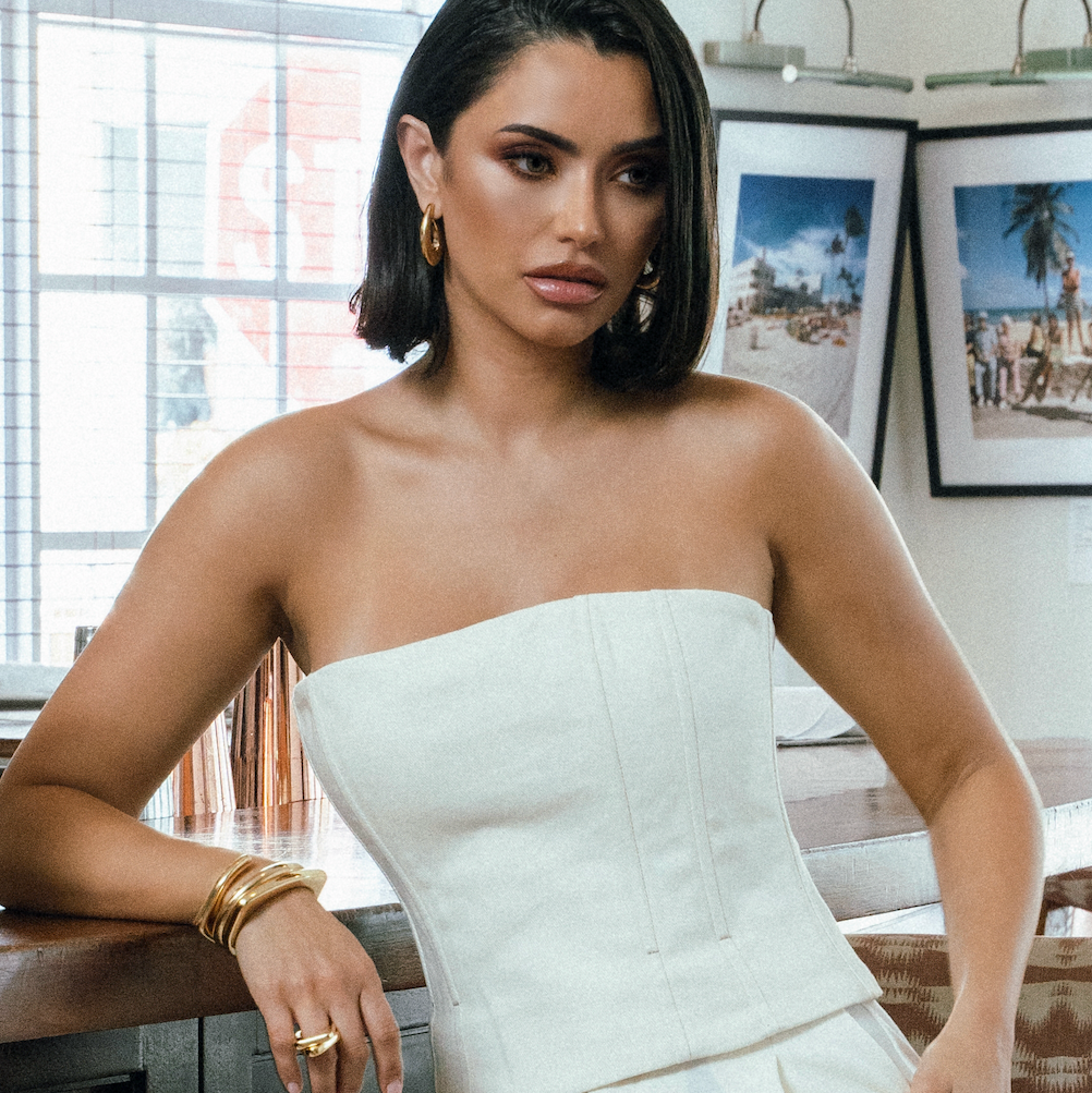 Sculptural hoop earrings available in gold plated and rhodium plated finishes with curved modern design