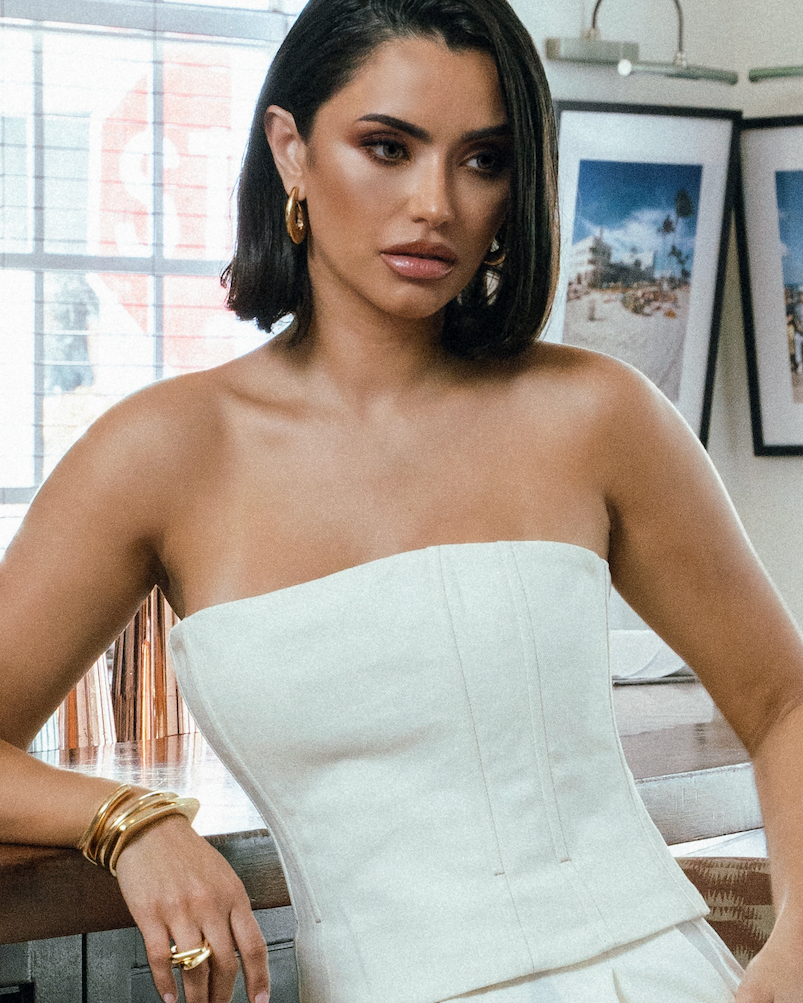 Sculptural hoop earrings available in gold plated and rhodium plated finishes with curved modern design