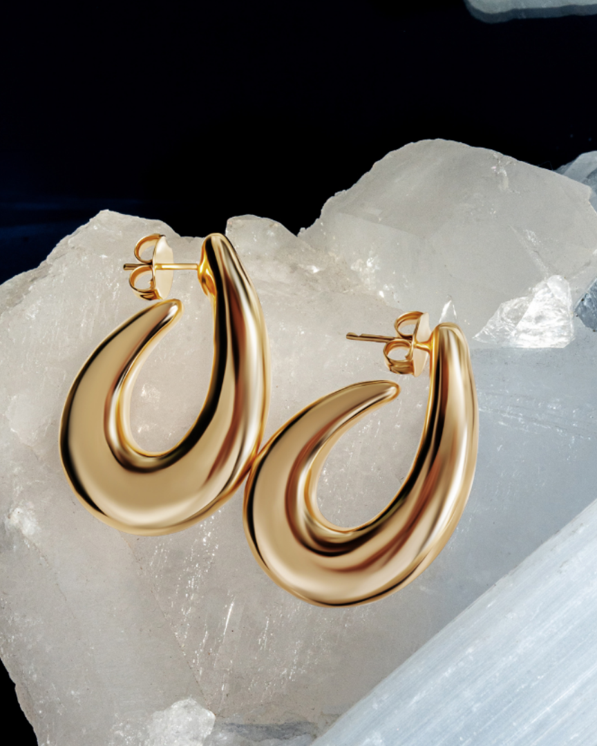 Sculptural hoop earrings available in gold plated and rhodium plated finishes with curved modern design