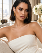a model wearing a Chunky teardrop gold hoop earrings 