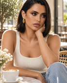 a model wearing a Chunky teardrop gold hoop earrings 