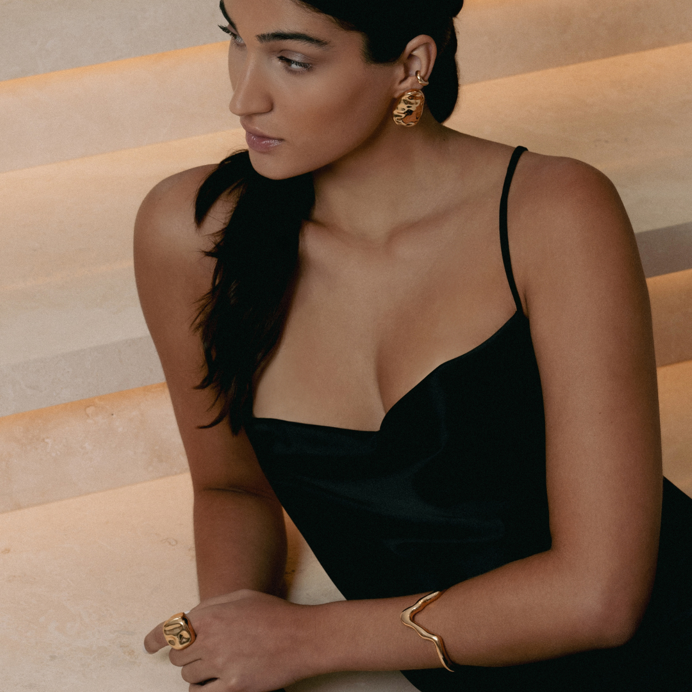 Gold oval sculptural earrings with smooth curved design and polished finish