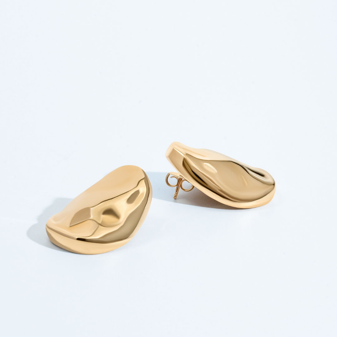Gold oval sculptural earrings with smooth curved design and polished finish