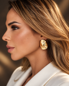 a model wearing a Sculptural teardrop gold earrings