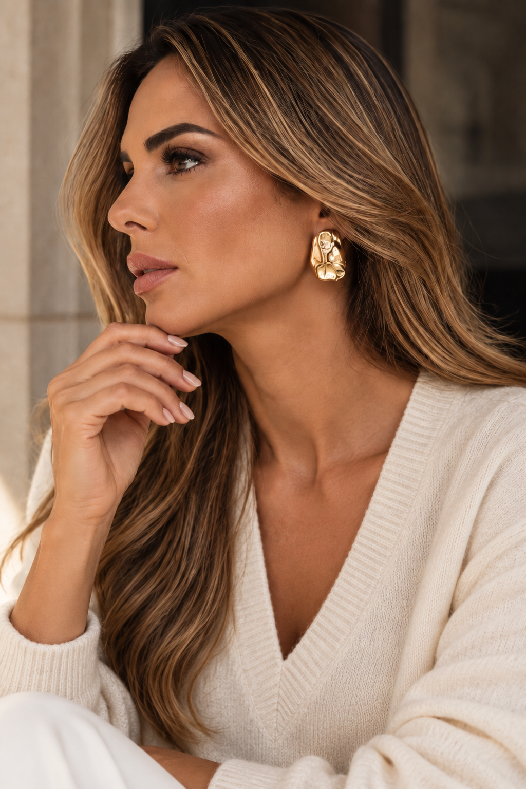 a model wearing a Sculptural teardrop gold earrings