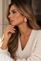 a model wearing a Sculptural teardrop gold earrings