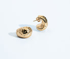 Gold sculptural earrings with compact organic texture and polished finish