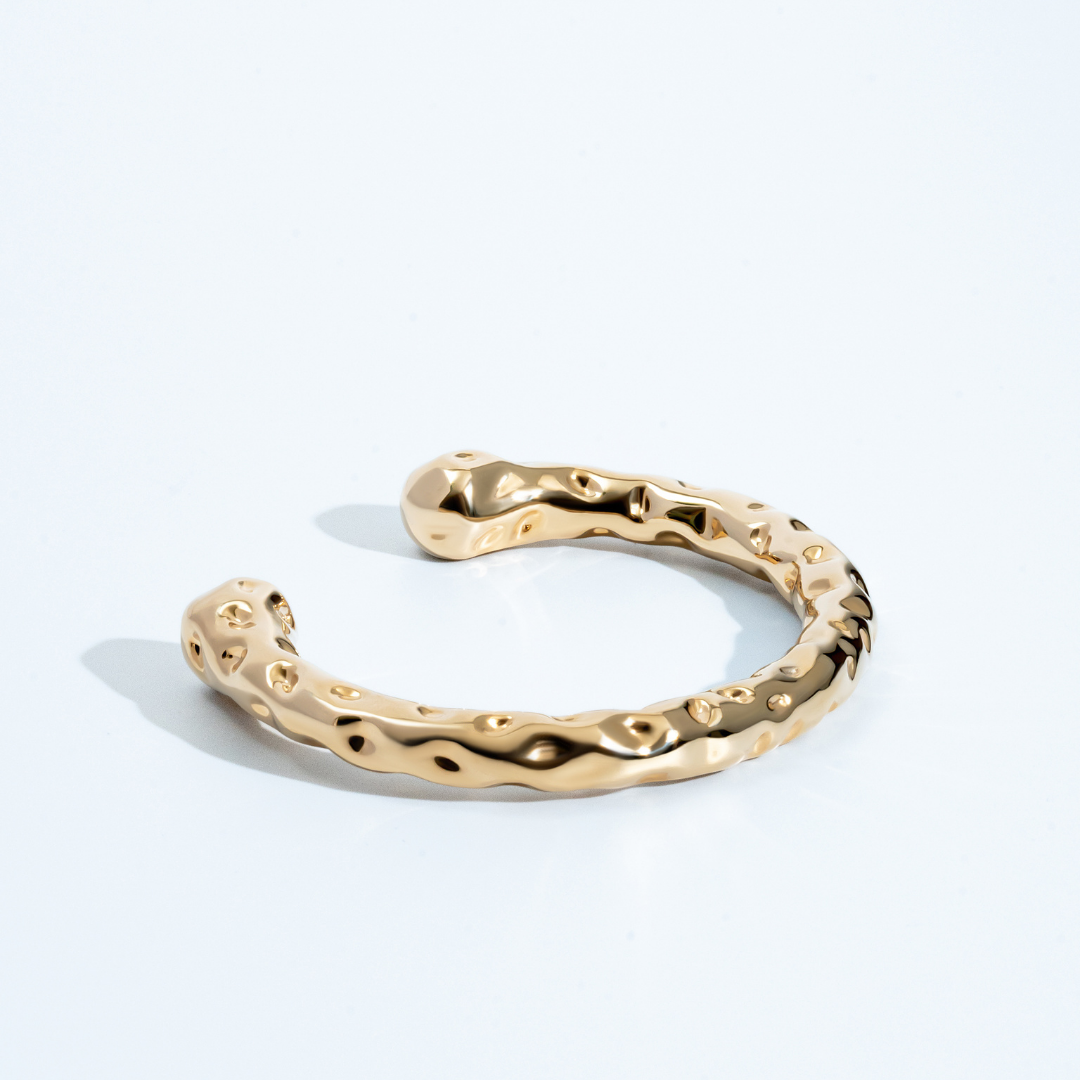 Gold molten textured cuff bracelet with organic sculptural design and 8mm thickness