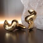 Gold plated twisted hoop earrings with thick sculptural design and asymmetrical shape, 60mm by 29mm