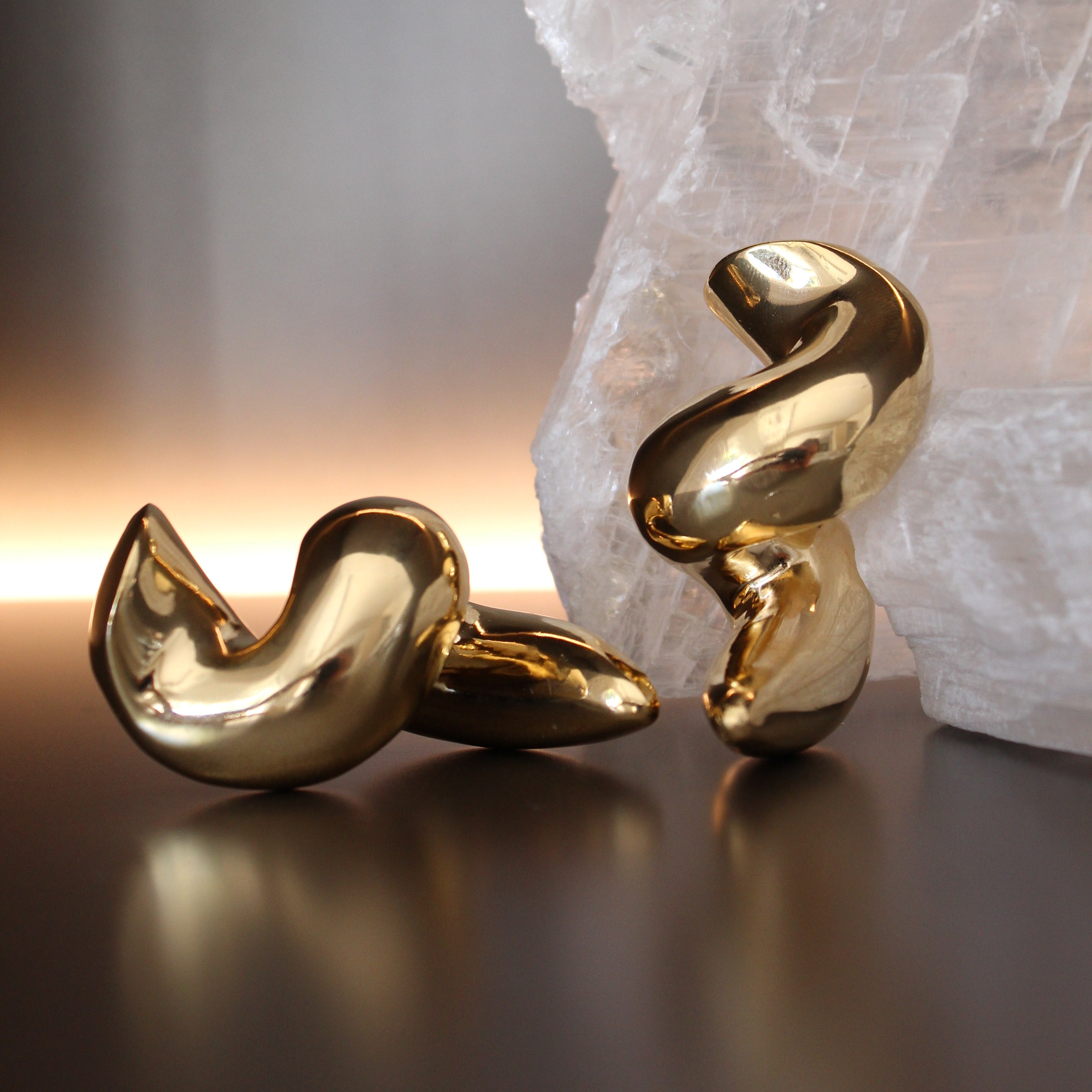 Gold plated twisted hoop earrings with thick sculptural design and asymmetrical shape, 60mm by 29mm