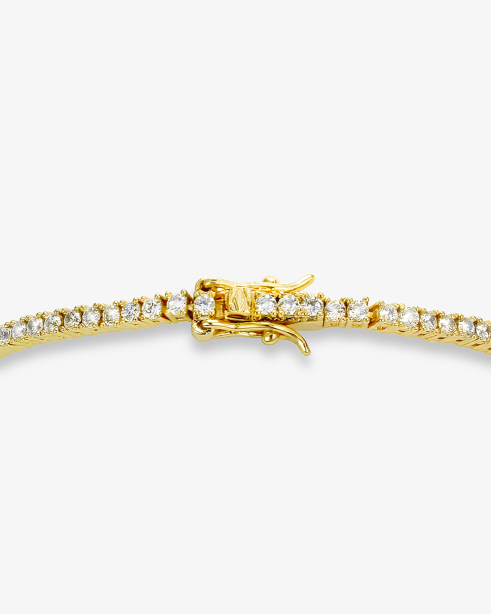 2mm gold tennis bracelet with round-cut clear stones and secure clasp
