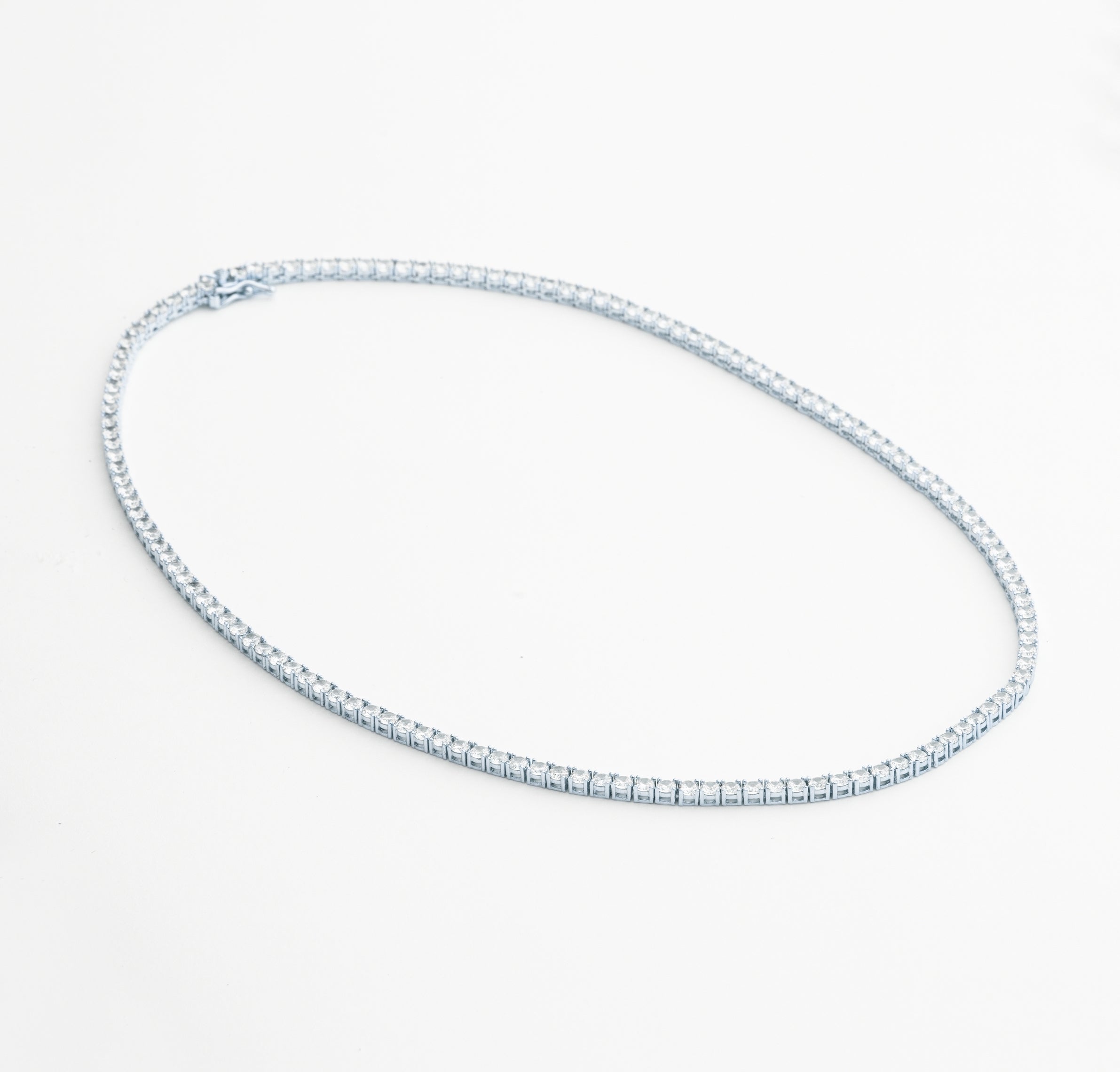 Tennis necklace and bracelet set with cubic zirconia stones available in gold plated and rhodium finishes