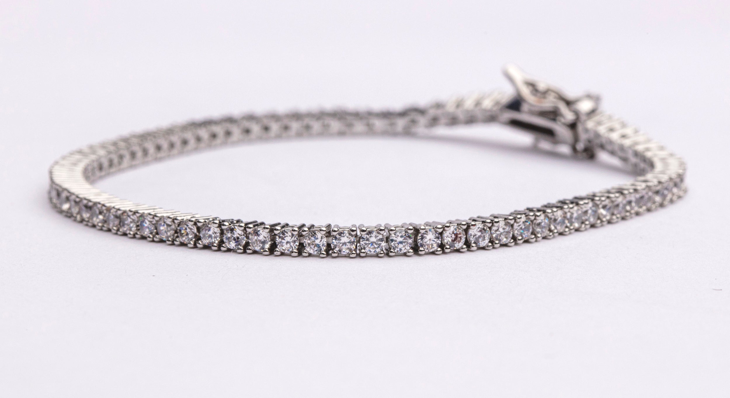 Tennis necklace and bracelet set with cubic zirconia stones available in gold plated and rhodium finishes