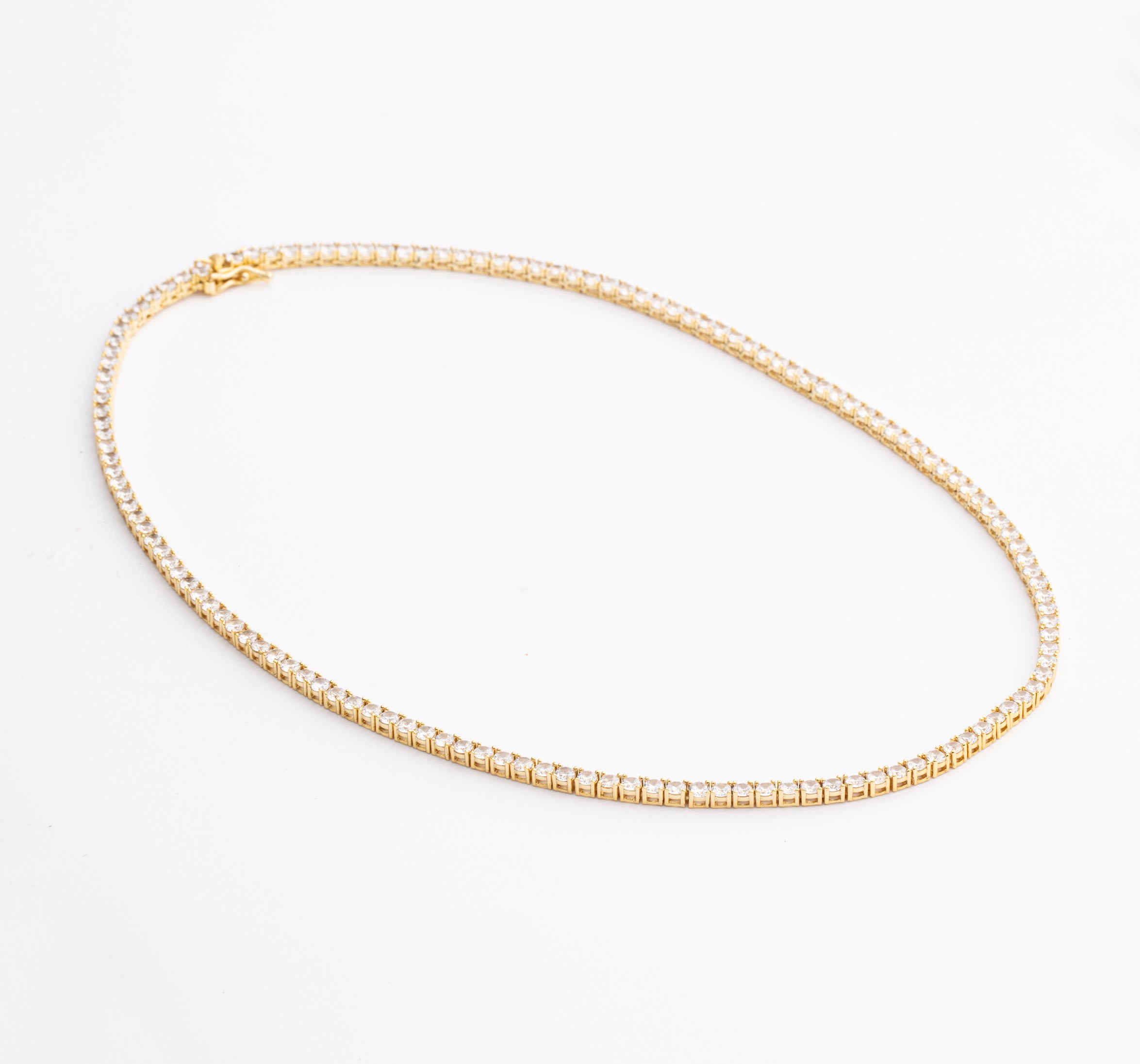 Tennis necklace and bracelet set with cubic zirconia stones available in gold plated and rhodium finishes