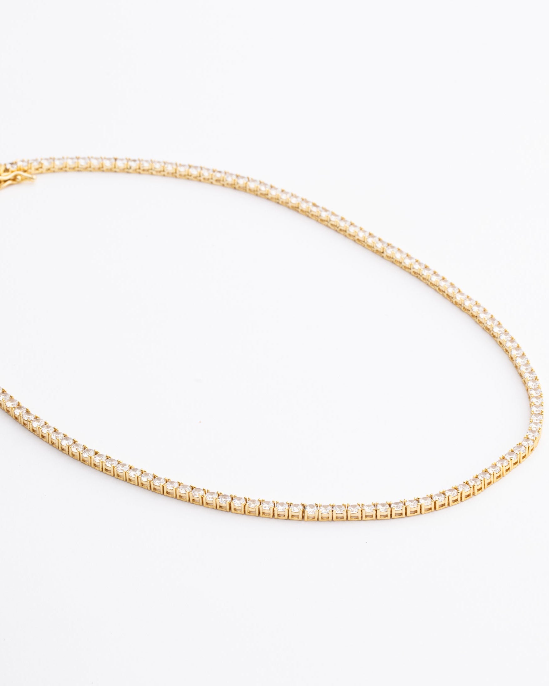 Tennis necklace and bracelet set with cubic zirconia stones available in gold plated and rhodium finishes