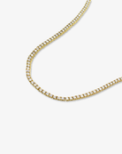 Gold tennis necklace with sparkling round clear stones angled view