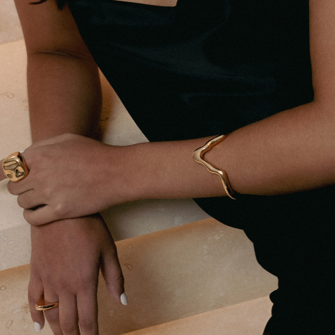 Gold sculptural bracelet with organic curved design and polished finish