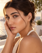 a model wearing a Sculptural triple loop gold ear cuff 