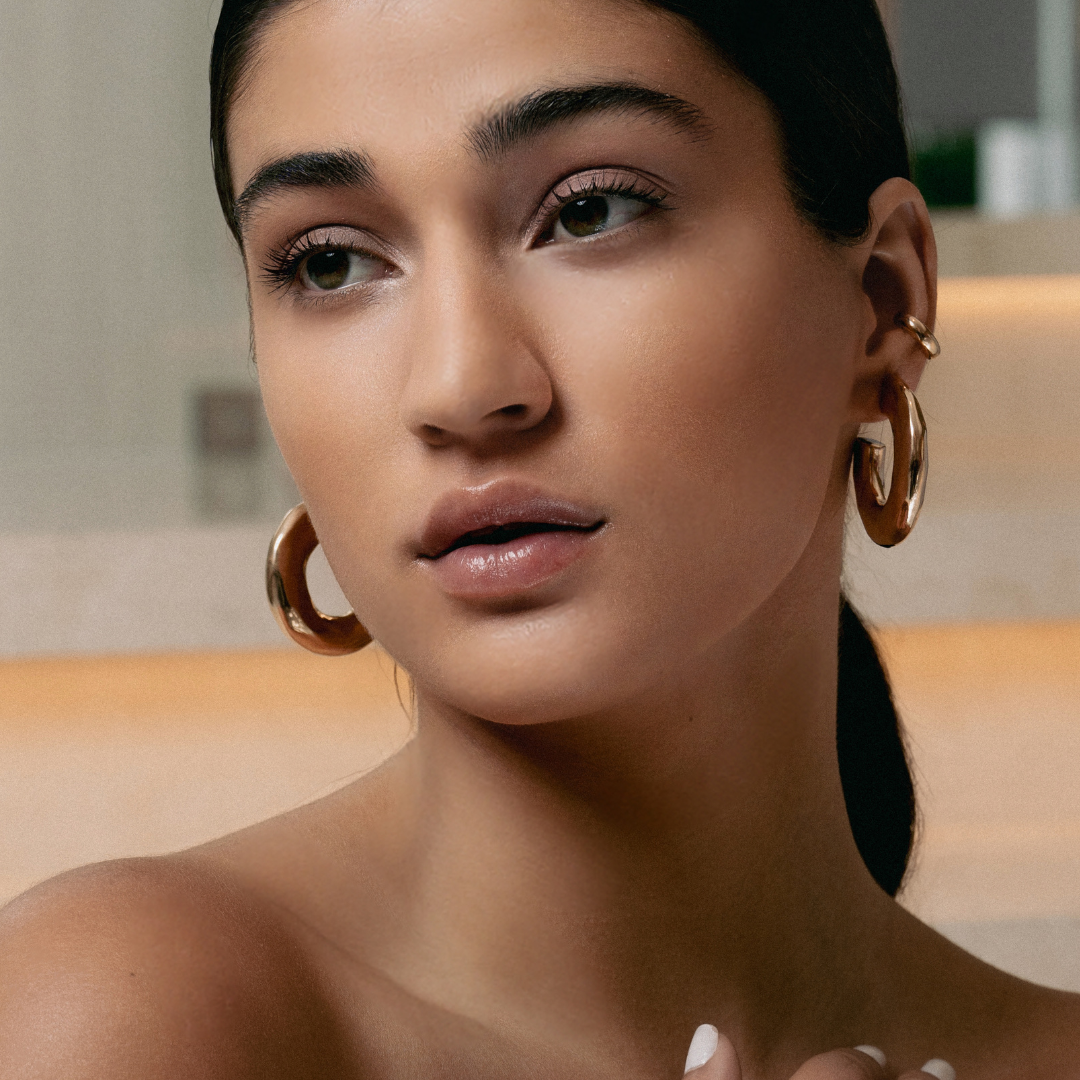 Hammered open hoop earrings available in gold plated and rhodium plated finishes with sculptural texture