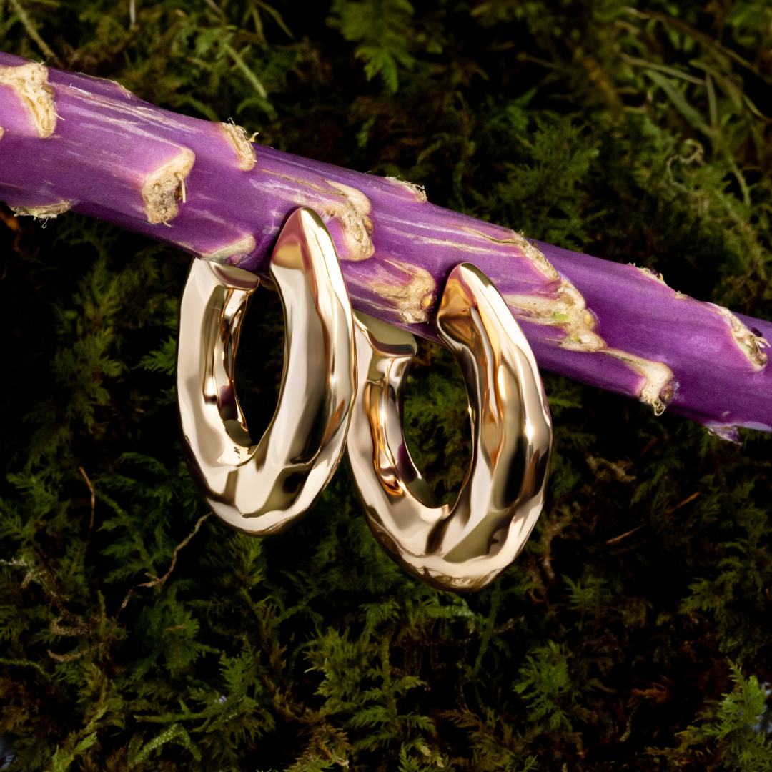 Hammered open hoop earrings available in gold plated and rhodium plated finishes with sculptural texture