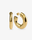 Chunky organic gold hoop earrings with sculptural curved shape and polished finish