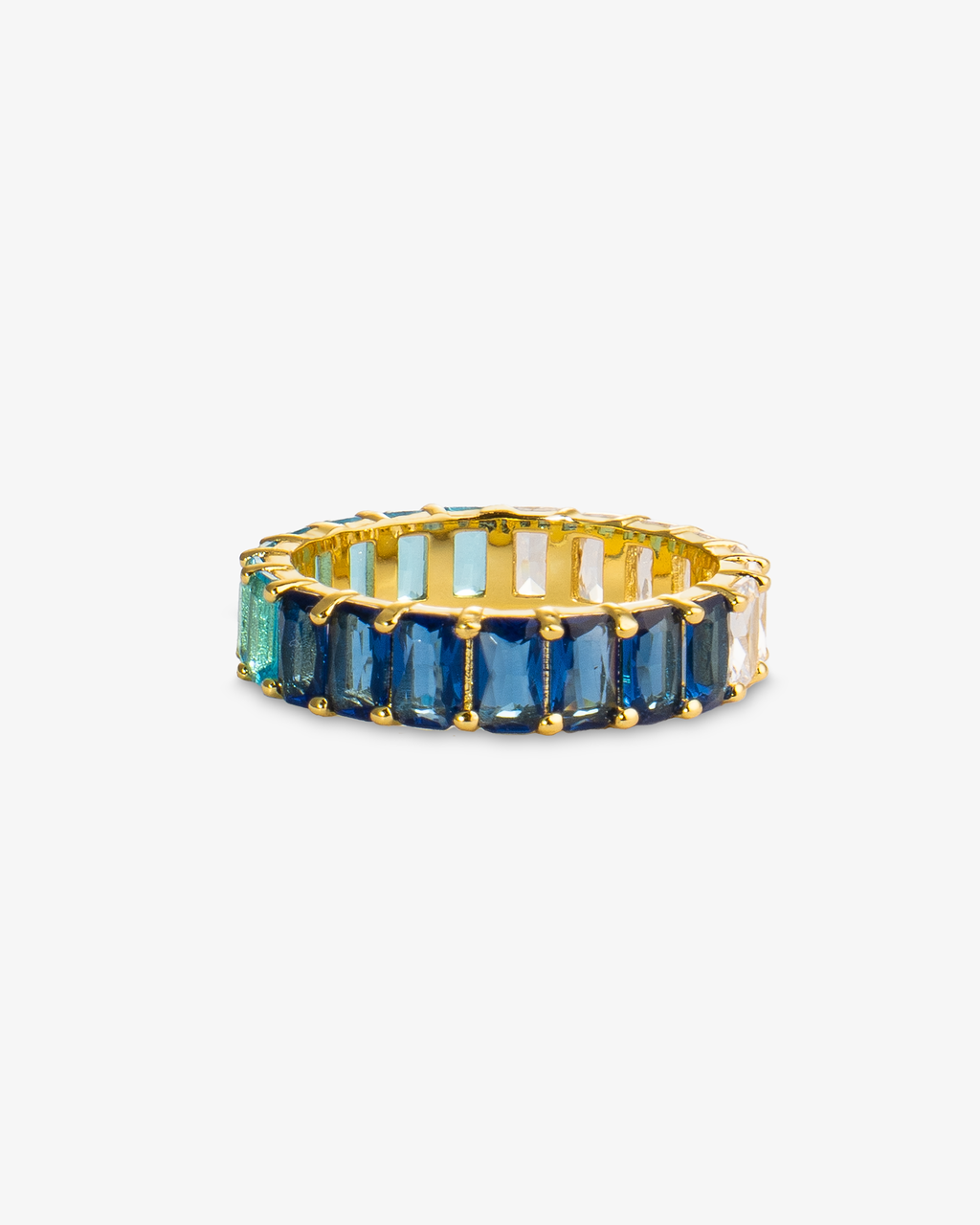 Gold eternity ring with dark-to-light blue ombre simulated diamond stones, alone product shot from a different angle.