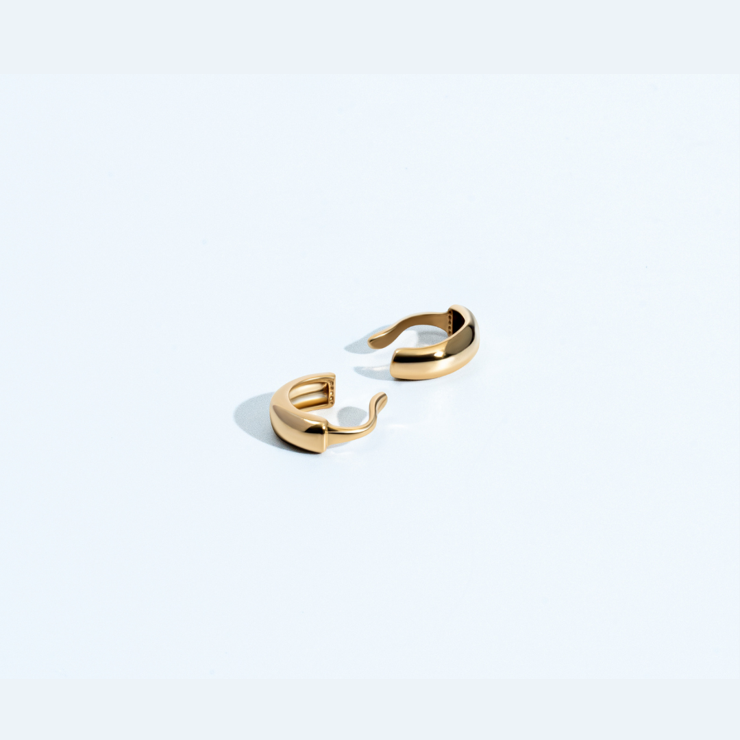 Gold thin ear cuff with minimal curved design and polished finish