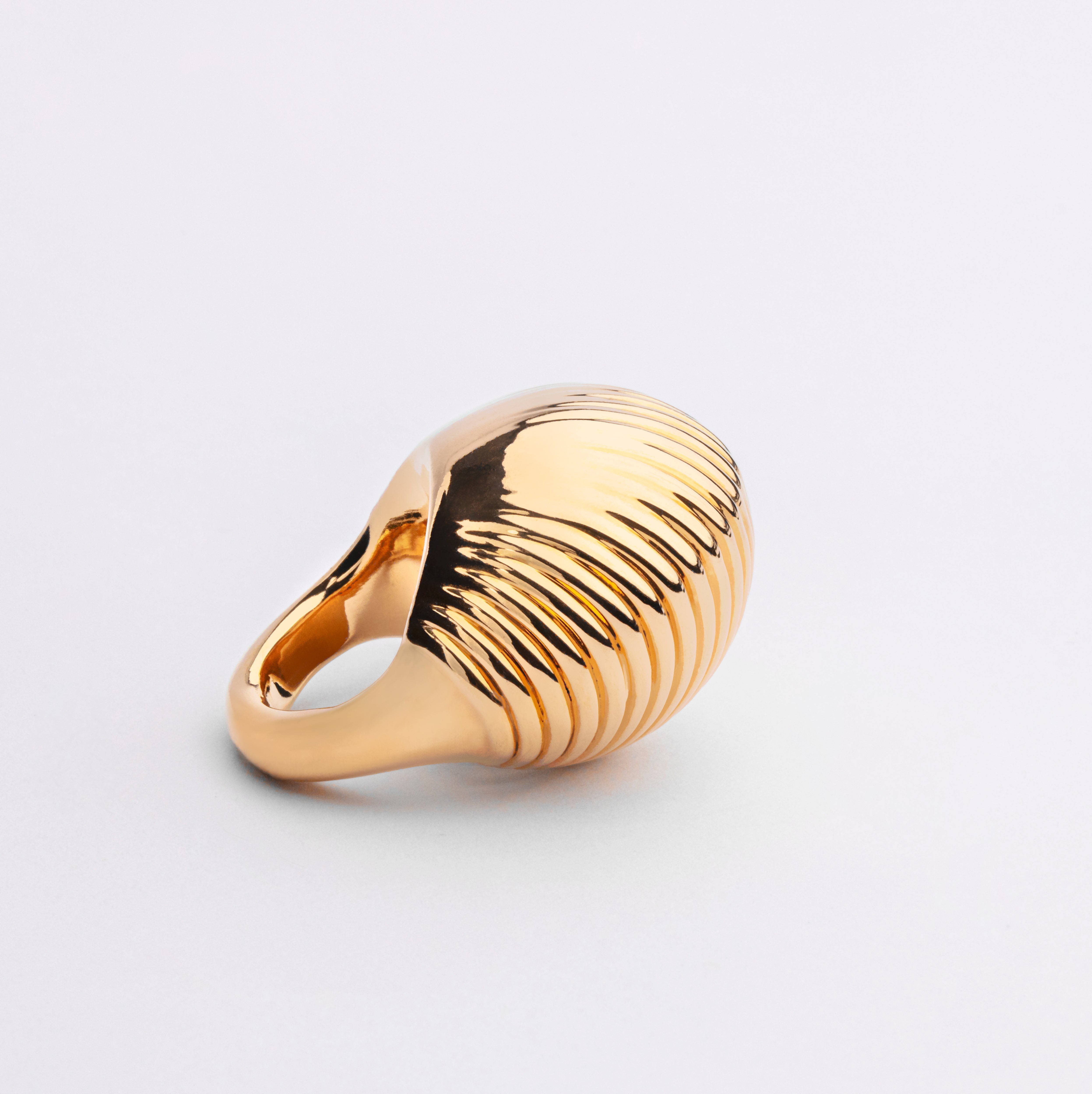 Gold plated bold sculptural ring with solid form and polished finish