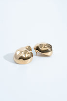 Dome earrings available in gold plated and rhodium plated finishes with dented sculptural texture