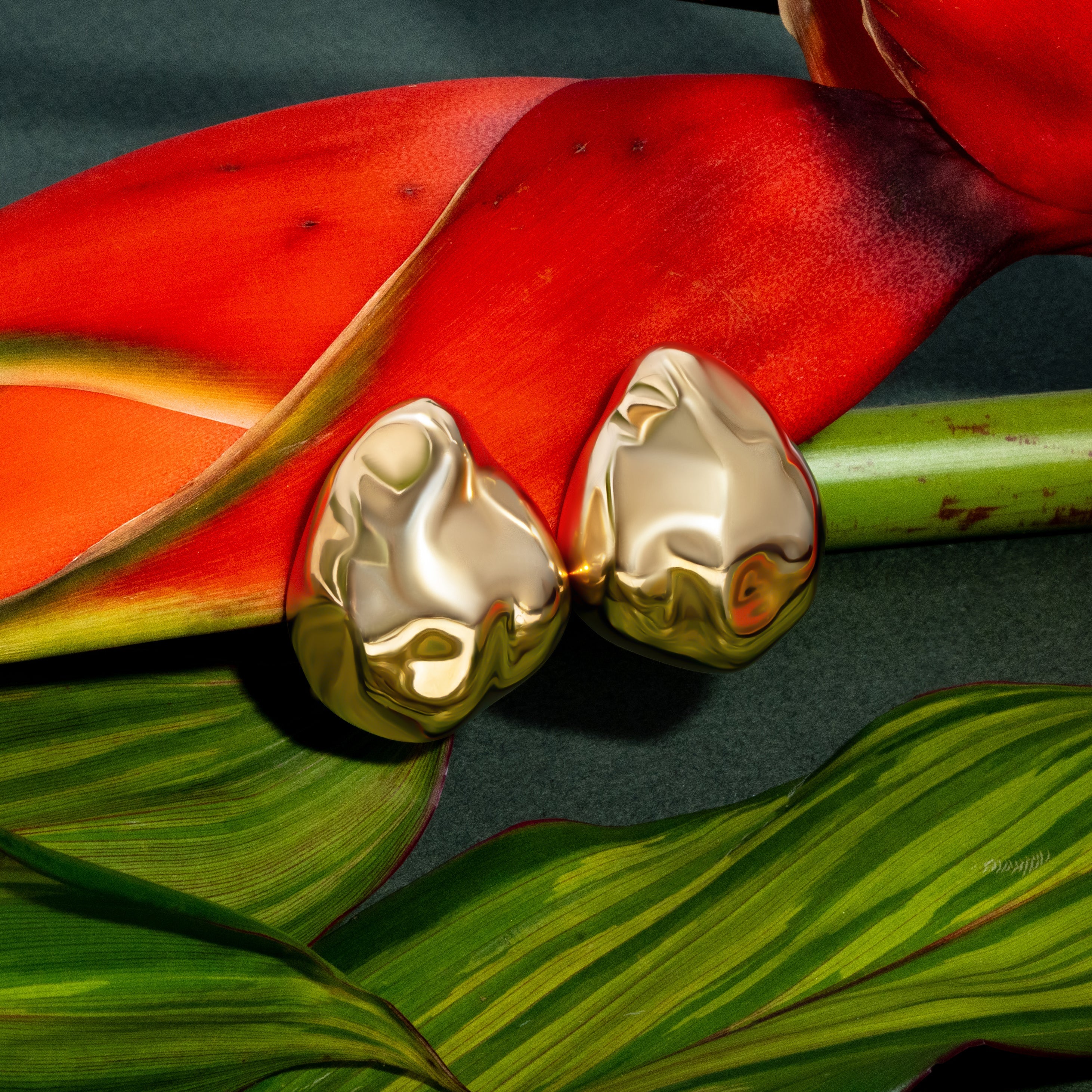 Dome earrings available in gold plated and rhodium plated finishes with dented sculptural texture