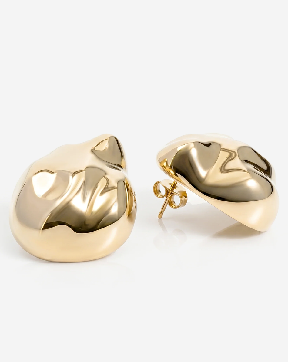 Dome earrings available in gold plated and rhodium plated finishes with dented sculptural texture