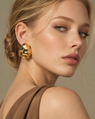a model earing a Organic pebble gold statement earrings