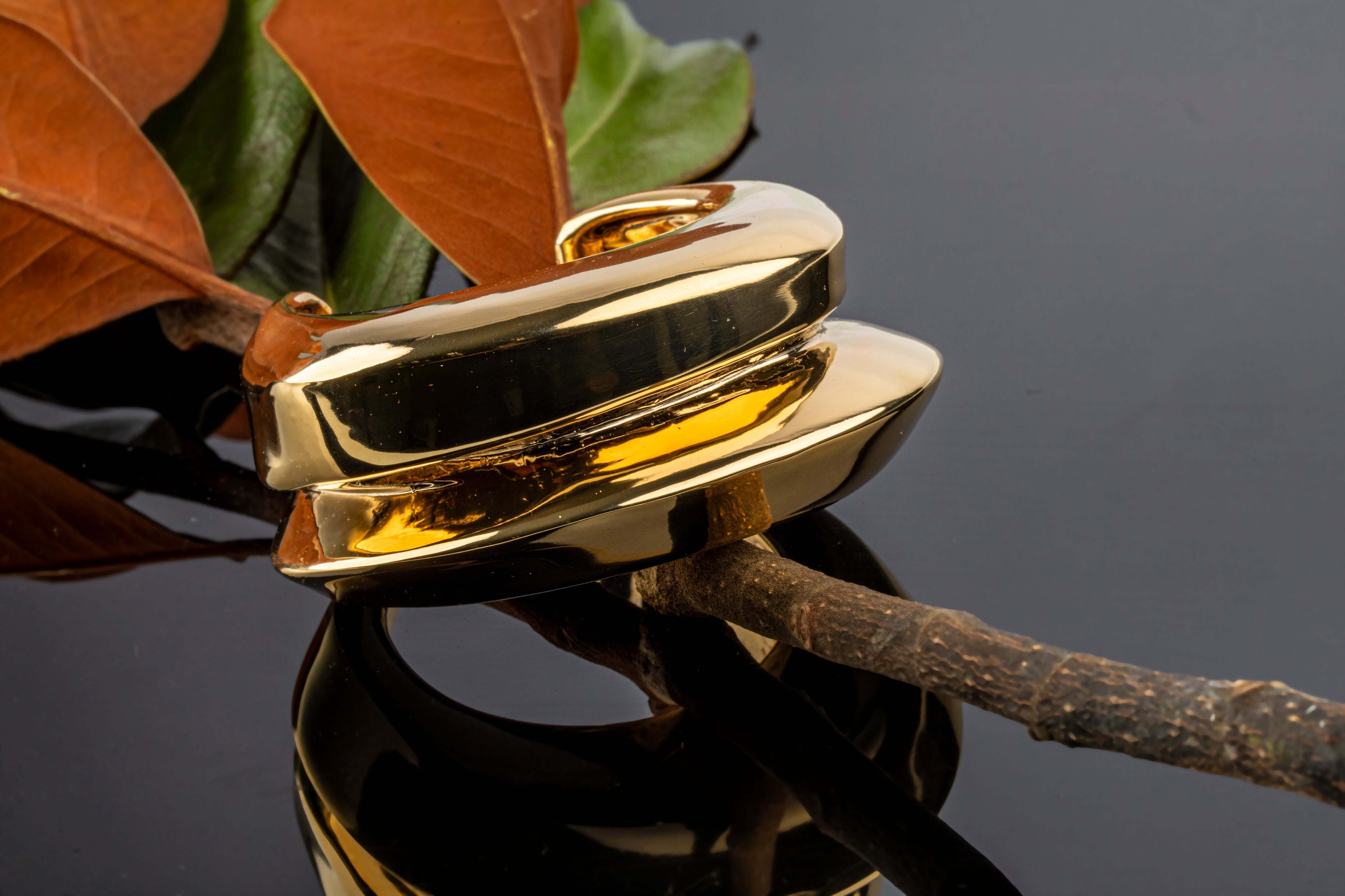 Gold plated wide cuff bracelet with open structured design and smooth polished surface, 40mm