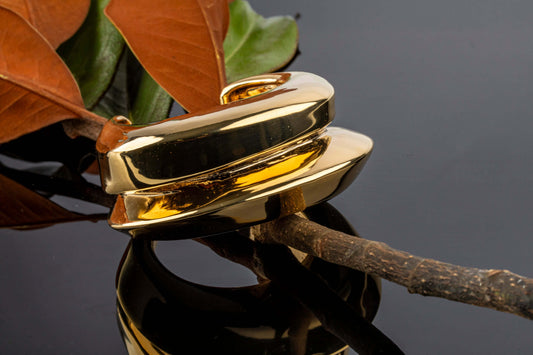 Gold plated wide cuff bracelet with open structured design and smooth polished surface, 40mm