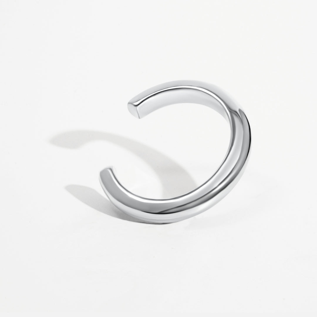 Sculptural cuff bracelet available in gold plated and rhodium plated finishes with bold circular design
