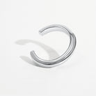 Sculptural cuff bracelet available in gold plated and rhodium plated finishes with bold circular design
