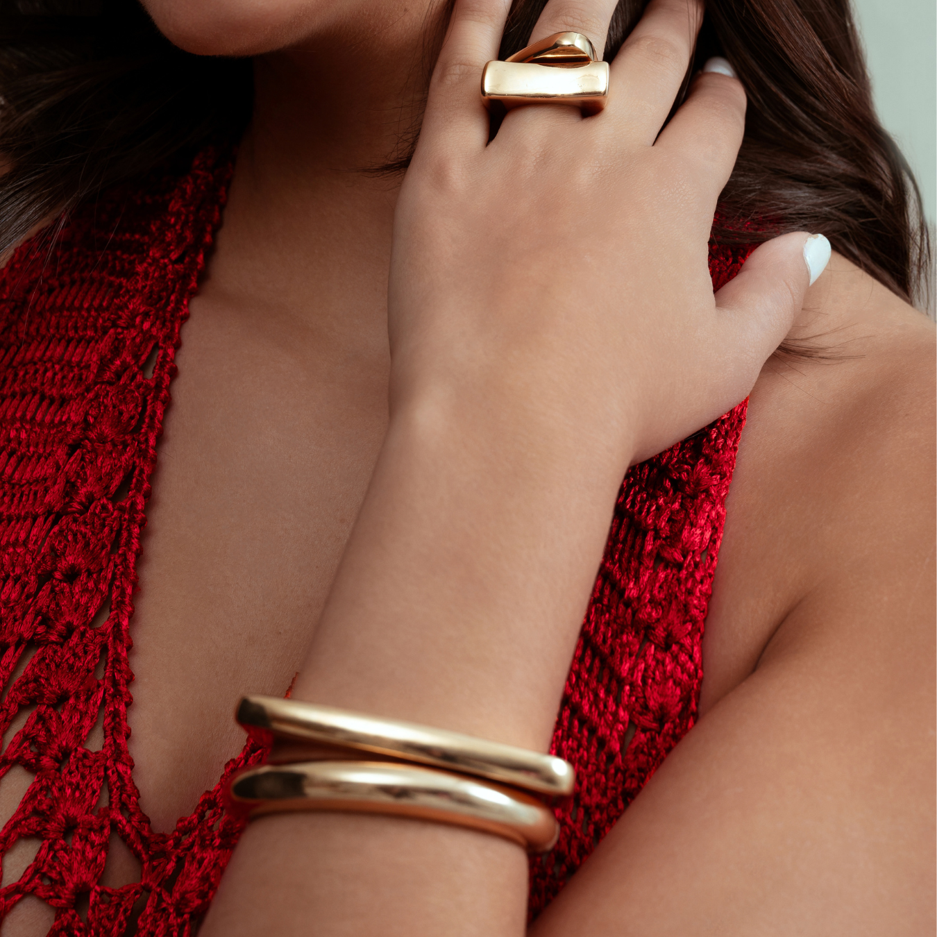 Sculptural cuff bracelet available in gold plated and rhodium plated finishes with bold circular design