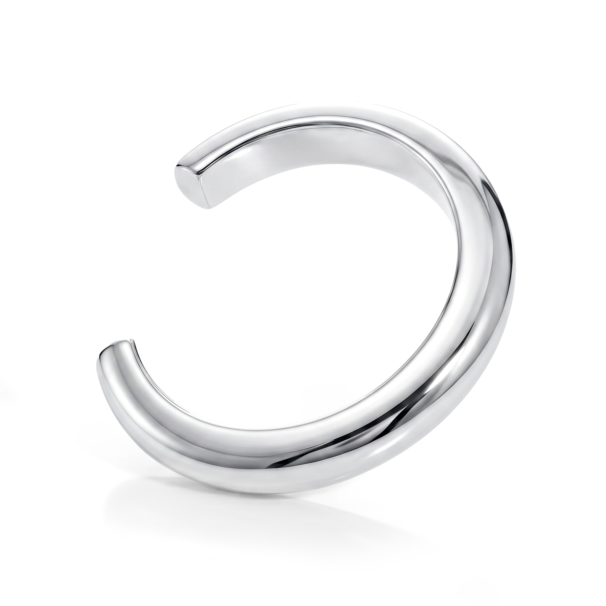 Sculptural cuff bracelet available in gold plated and rhodium plated finishes with bold circular design